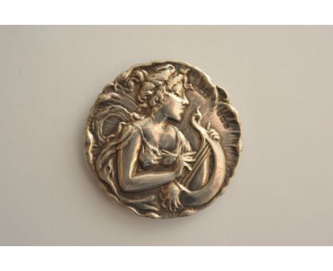 An Art Nouveau silver buckle having wavy rim with a central maiden playing a harp bearing Birmingham hallmarks for 1902