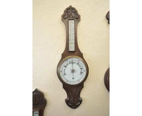A carved oak wall barometer
