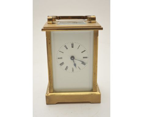 A brass carriage clock, the enamel dial with Roman numerals 