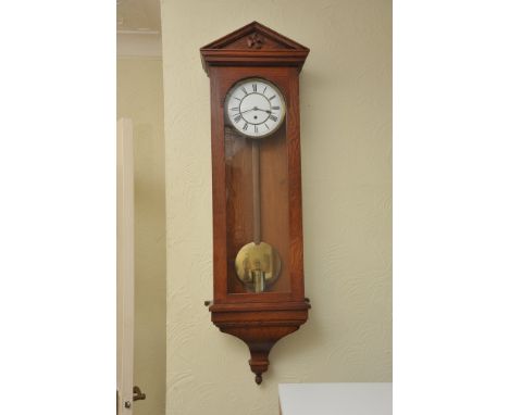 An oak cased Vienna type regulator clock with an enamel dial and single weight 