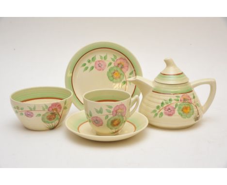 A Clarice Cliff 'Corolla' pattern part teaset comprising small teapot, a cup and saucer trio and sugar bowl