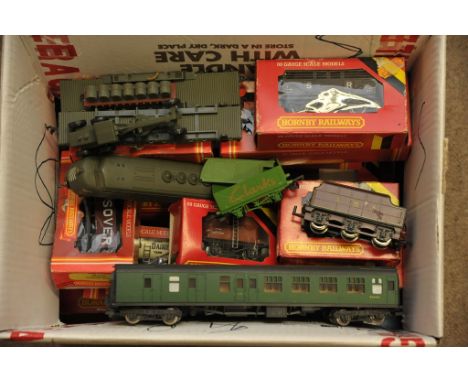 A collection of boxed and unboxed Hornby 00 gauge railway carriages and goods trucks including a 'Cox' US Army set