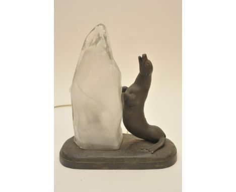 A French Art Deco lamp formed as a seal leaning against glacier shaped glass shade