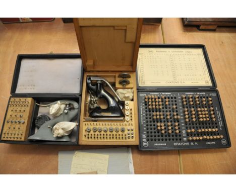 Two boxed watchmakers jewel setting tools together with a box containing various ruby jewels