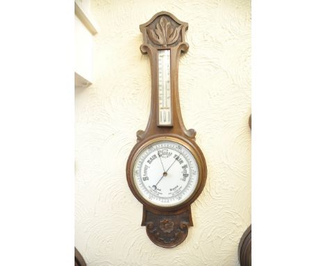 A carved oak Aneroid wall barometer 
