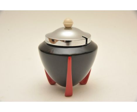 An Art Deco Wilkinson 'Yoo Hoo' pattern sugar pot with black body on red tripod feet having chrome lid, designed attributed t