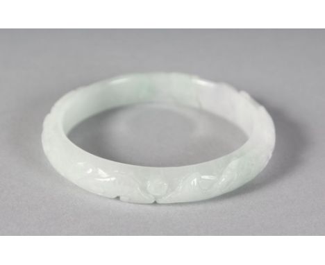 A CHINESE CARVED WHITE DIAMOND BANGLE.