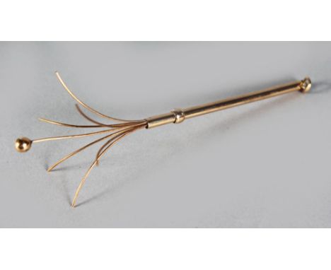 A 9CT GOLD SWIZZLE STICK.