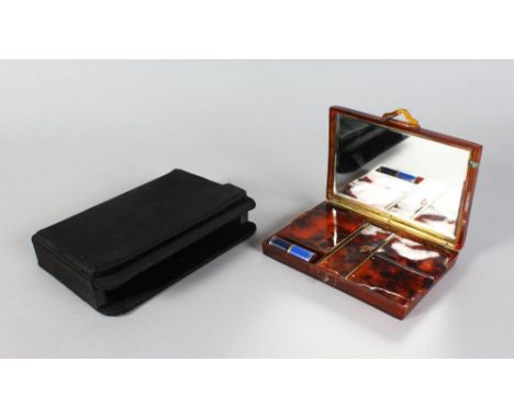 A CHRISTIAN DIOR VANITY CASE, tortoiseshell, in a black silk purse.