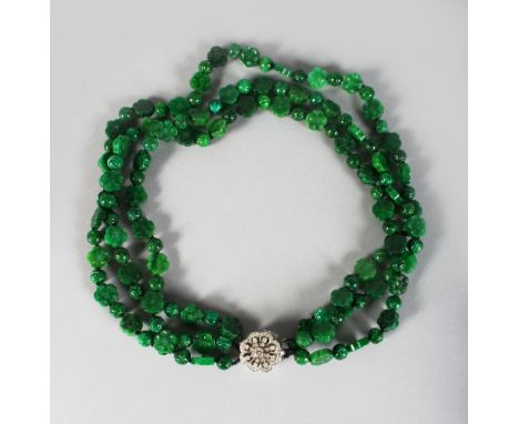 A SUPERB CARVED JADE THREE ROW NECKLACE with 18CT WHITE GOLD DIAMOND SET CLASP.