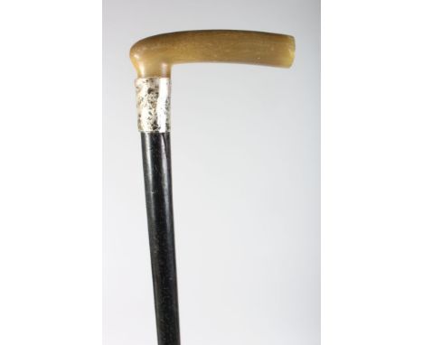A POSSIBLY RHINO HORN HANDLE WALKING STICK with silver band.
