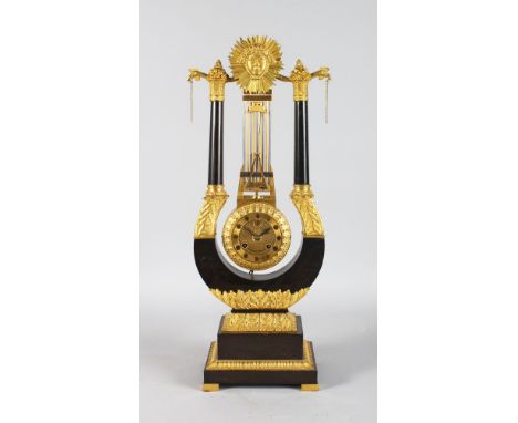 A SUPERB REGENCY LYRE SHAPED MYSTERY CLOCK, the top with a sunburst fruiting finial, curving supports with eight-day striking