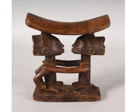A CARVED WOOD TRIBAL STOOL HEADREST. 7ins high.