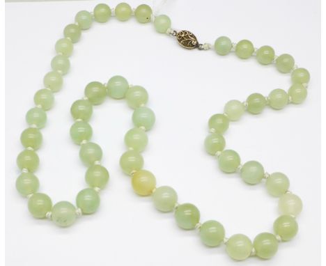 A jade necklace with a silver clasp