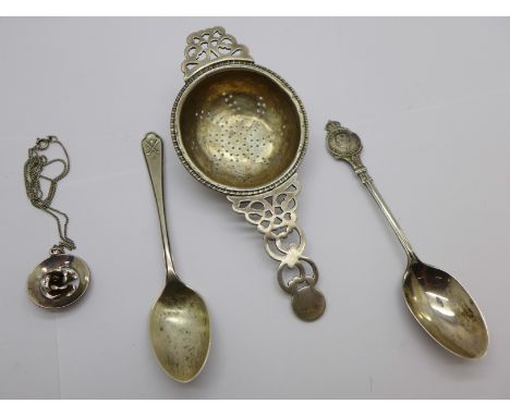 A silver tea strainer, two silver spoons and a silver pendant and chain, 58g