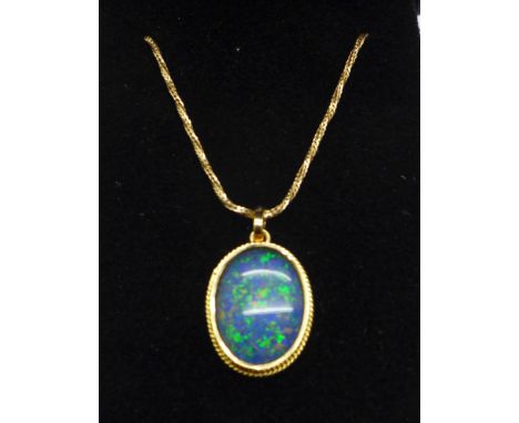 A doublet opal pendant on a plated chain 