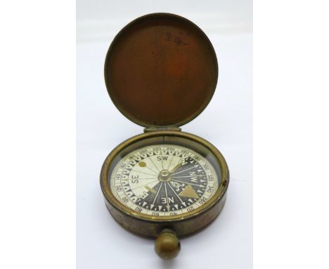 A brass pocket compass, lacking loop