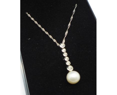 An 18ct gold, pearl and diamond pendant on a 9ct gold chain, 3.7g