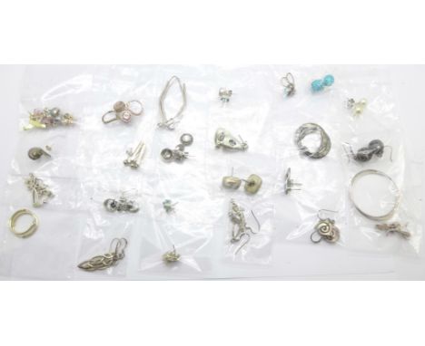 Twenty-five pairs of silver earrings