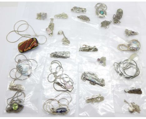 Twenty-five silver pendants and chains