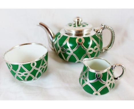 Royal Worcester three piece bachelor tea service with hallmarked silver lattice work, assay Birmingham 1910 