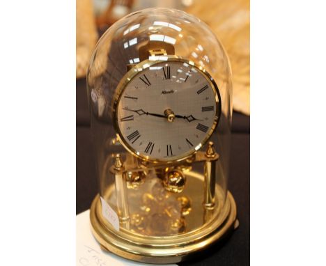 Brass carriage clock encased in glass dome