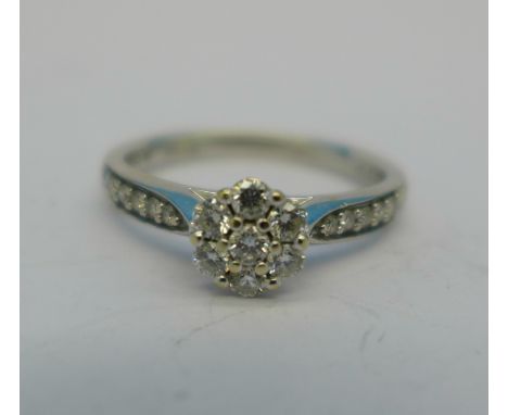 An 18ct white gold and diamond cluster ring with diamond shoulders, 3g, L