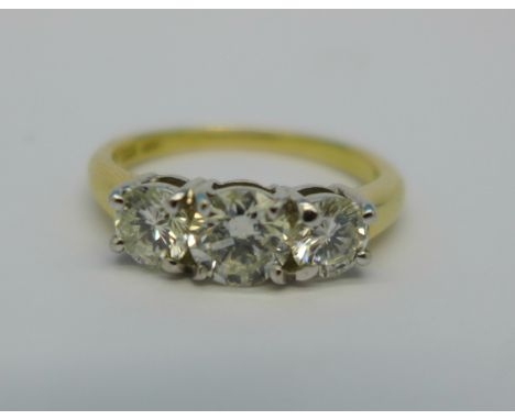 An 18ct gold, three stone diamond ring, centre stone approximately 0.75 carat, 4.4g, N