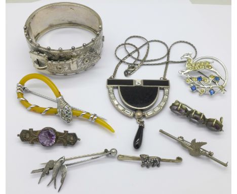 A Victorian 'buckle' bangle marked sterling silver, a small bulldog brooch set with old cut diamonds, lacking two, and other 