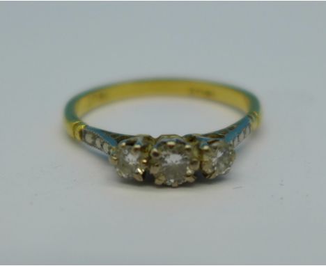 An 18ct gold and three stone diamond ring, 2g, M