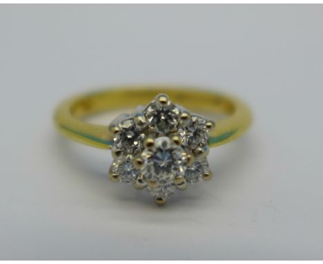 An 18ct gold, seven stone diamond cluster ring, stamped 0.50ct diamond weight, 4.1g, L½