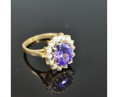 9ct gold purple and clear stone cluster ring. 4.3g approx. Ring size L 1/2. (B.P. 21% + VAT)