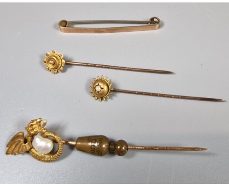 Two Edwardian flowerhead stick pins. 1.4g approx. Together with another stick pin marked 14K and a 9ct gold tie pin/brooch. (