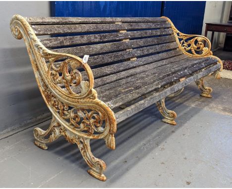 Heavy cast iron scrolled foliate design garden bench with centre cast iron support and wooden slats. 186cm wide approx. (B.P.