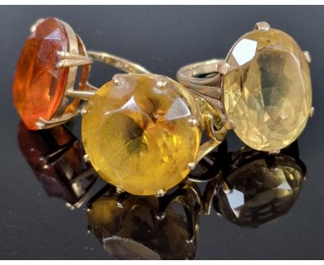Three 9ct gold dress rings inset with orange and yellow stones. 20g approx. Ring sizes P 1/2, M 1/2 and O. (3) (B.P. 21% + VA