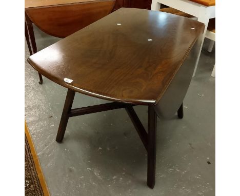 Mid-century elm Ercol drop-leaf table on X frame supports. (B.P. 21% + VAT)