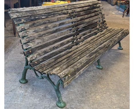 Slatted wooden garden bench with three part cast iron underframe. 182cm wide approx. (B.P. 21% + VAT)