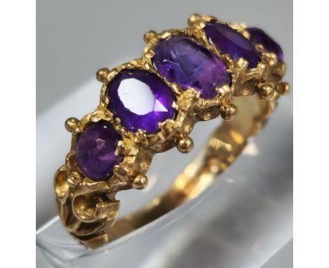 9ct gold five stone purple dress ring. 3.1g approx. Ring size J. (B.P. 21% + VAT)