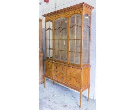 DISPLAY CABINET ON STAND, Edwardian Sheraton Revival satinwood,with glazed upper over twin drawers and cupboard doors, with a