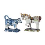 A DUTCH DELFT POLYCHROME MODEL OF A SADDLED HORSE AND A BLUE AND WHITE COW-CREAMER, CIRCA 1900