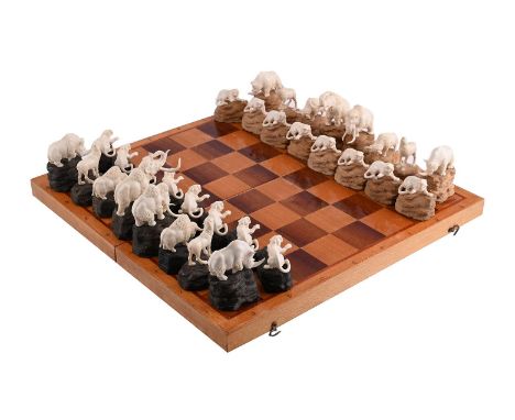 Y&nbspA RUSSIAN WOOLLY MAMMOTH IVORY 'ANIMALIER' CHESS SET LATE 20TH CENTURY, CARVED BY EUGENI KOLESNIKOV AND RETAILED THROUG
