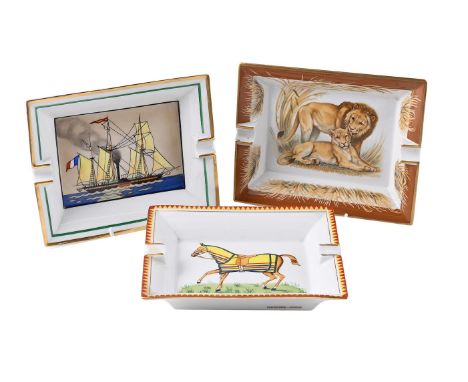 HERMES, PARIS, A GROUP OF THREE ASH TRAYS  MODERN Comprising a pair of lions, a racehorse, and a ship gilt marks each 16 x 19