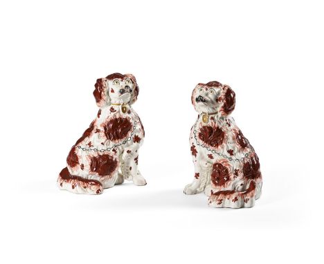 A PAIR OF STAFFORDSHIRE POTTERY MODELS OF SPANIELS MID 19TH CENTURY Modelled facing left and right and seated on their haunch
