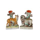 A PAIR OF STAFFORDSHIRE SPILL VASES MODELLED AS A LION AND A LEOPARD BEFORE A TREE, MID 19TH CENTURY