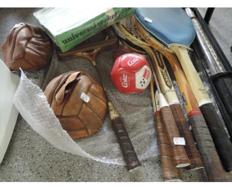 A selection of rackets, vintage footballs and Bullworker etc
