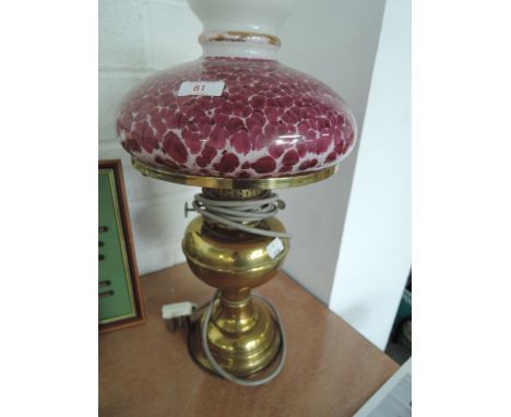 A brass gas lamp converted to electric with vintage glass shade. 
