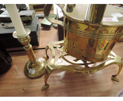 A brass water can, trivet and candlestick