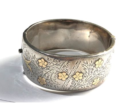 Antique silver &amp; gold detail cuff bangle measures approx 2.8cm wide back has age related dents as shown 