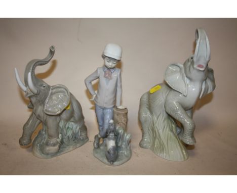 A NAO ELEPHANT FIGURE TOGETHER WITH ANOTHER AND A NAO FIGURE OF A BOY LEANING AGAINST A STUMP