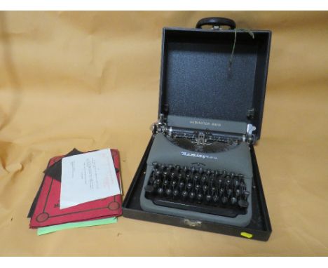 A CASED VINTAGE REMMINGTON RAND TYPE WRITER